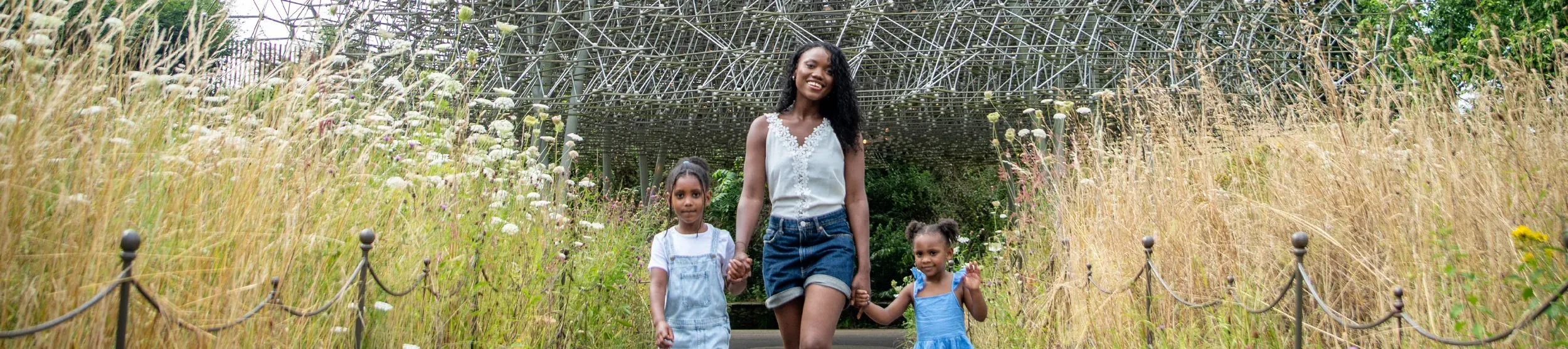 Family walking down the path at the Hive