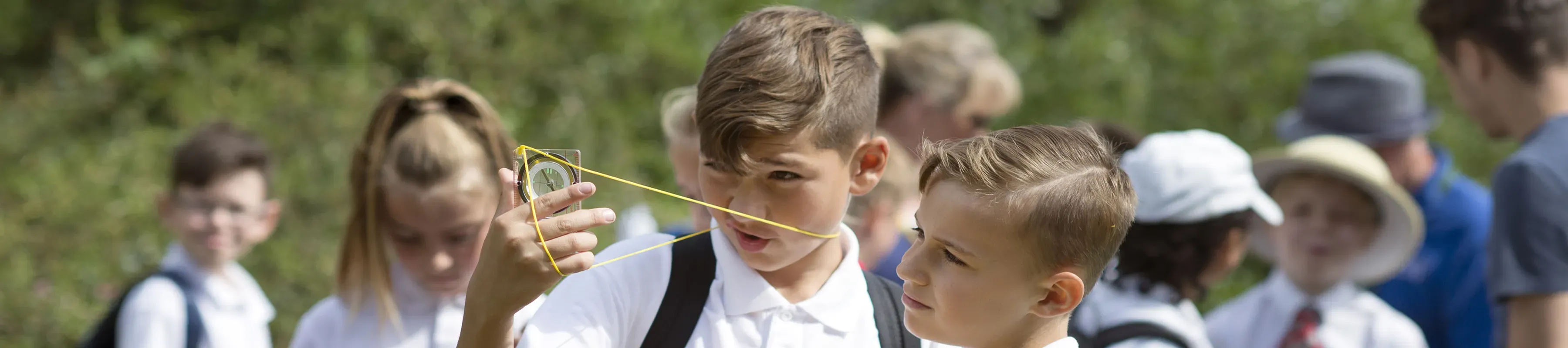 Pupils using maths equipment during a schools session