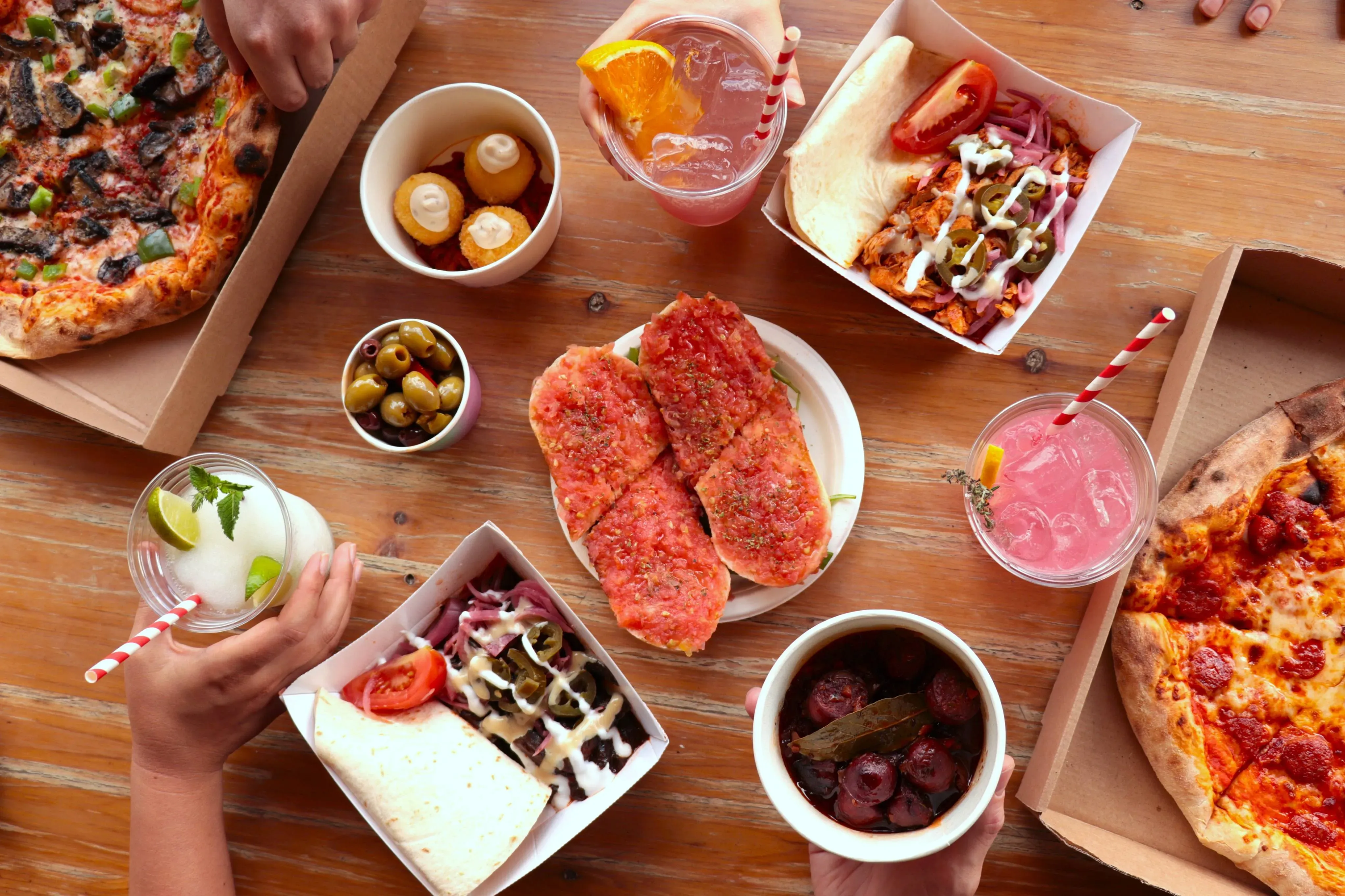 Pizza, shawarma and drinks on a table