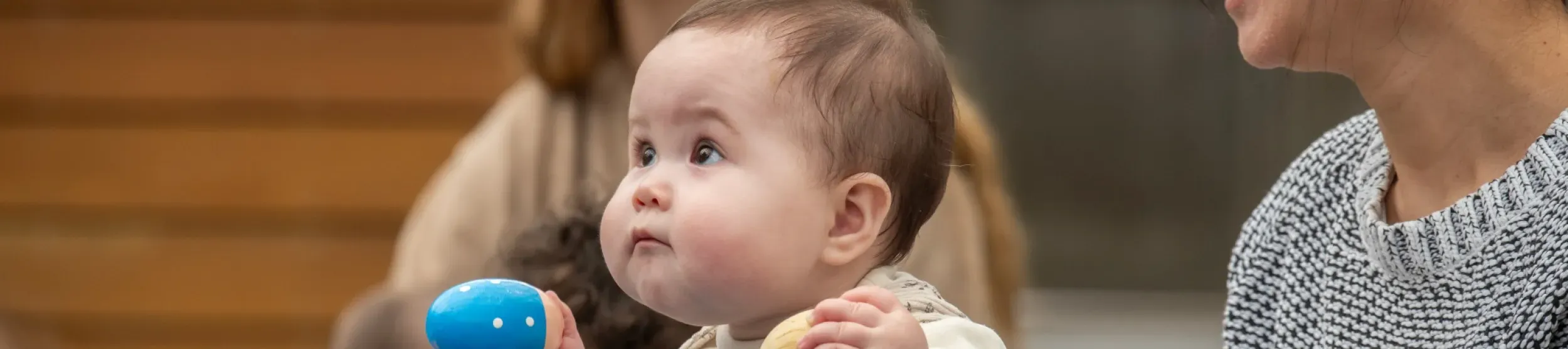 A young child playing with musical shakers