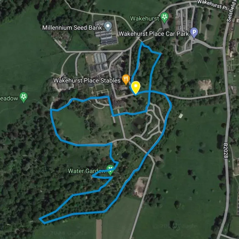 Map showing a blue trail through the grounds of Wakehurst