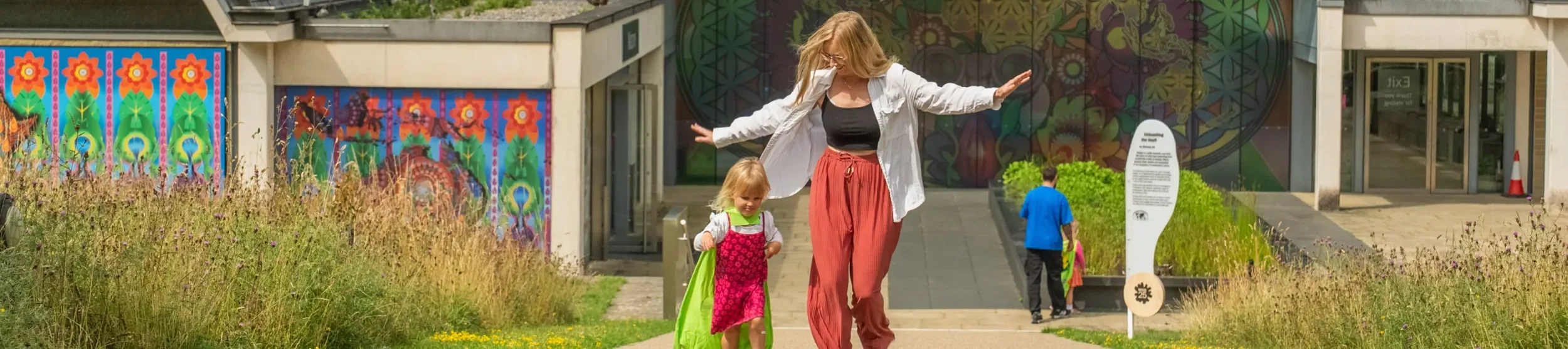 People playing in front of Wakehurst's Millennium Seed Bank